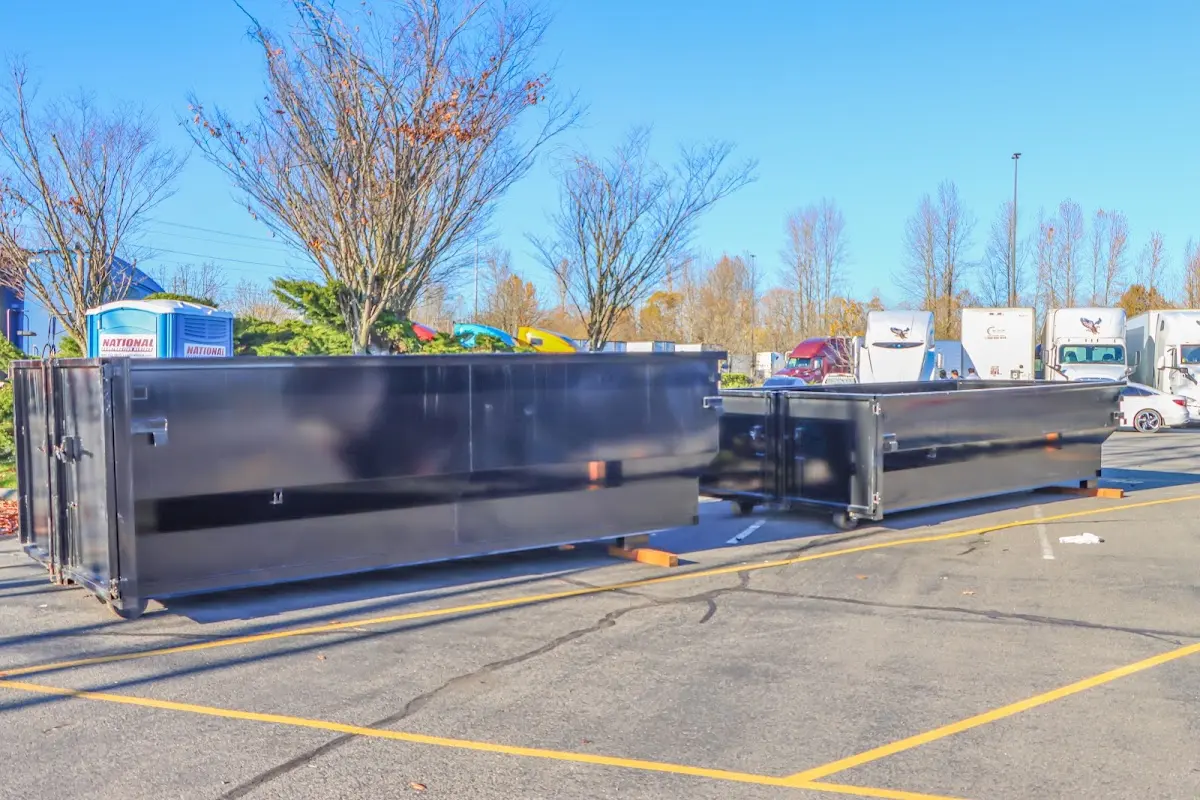 Professional dumpster rental service with roll-off container on residential driveway in Dayton